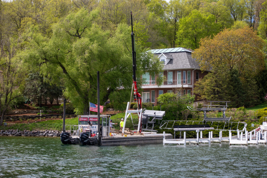 a boat dock with a house and trees in the background