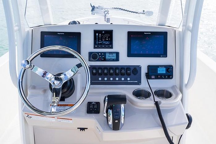 captains view of a boat on water steering wheel gps controls, basic boating skills