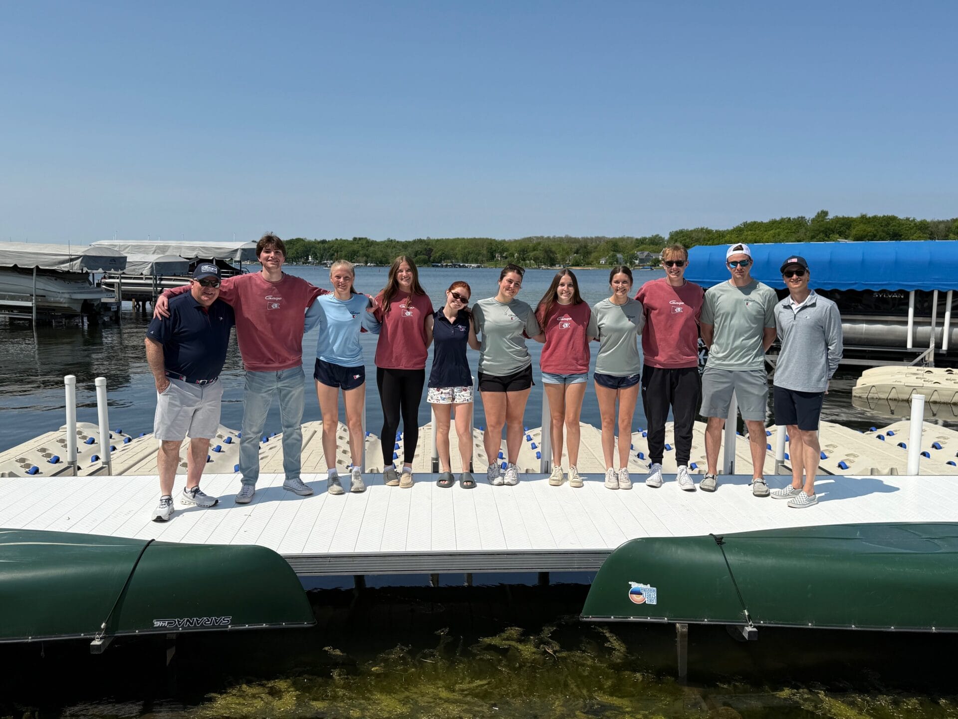 A group of people standing in front of the lake